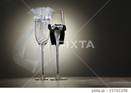 Two empty wineglass dressed in veil and wedding Two empty wineglass dressed in veil and wedding 25702206