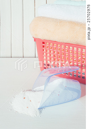 Bath towels and washing powder in measuring cup 25702976