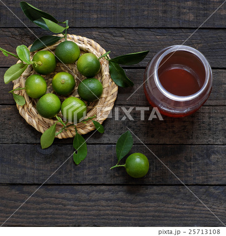 Green Kumquat fruit on wooden background Green Kumquat fruit on wooden background 25713108