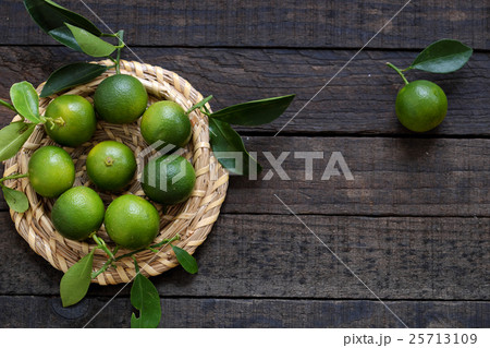 Green Kumquat fruit on wooden background Green Kumquat fruit on wooden background 25713109
