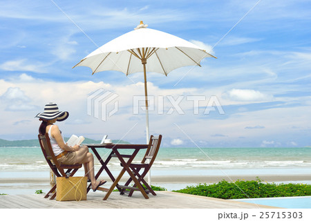 Young woman reading a book at the beach 25715303