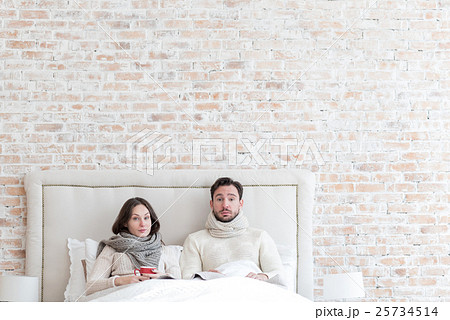 Sad unhappy couple lying in bed together 25734514