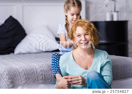 Cute granddaughter plaiting braids to her Cute granddaughter plaiting braids to her 25734827