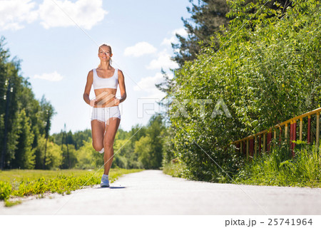 young athletic woman running on the road young athletic woman running on the road 25741964