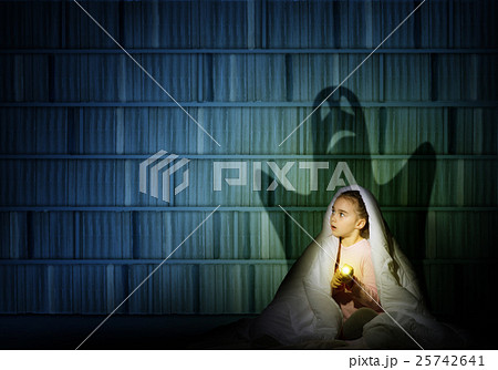 girl under the covers with a flashlight girl under the covers with a flashlight 25742641
