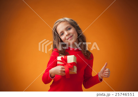 The cute cheerful little girl on orange background 25746551
