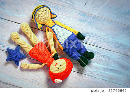 Crochet toys couple laying on a wooden background 25746645