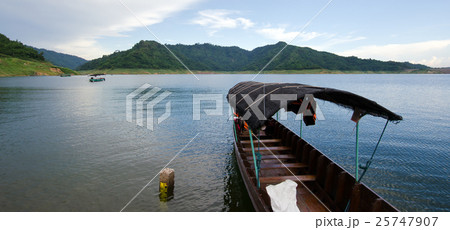 A fishing boat tied at the shore at Khun Dan dam 25747907