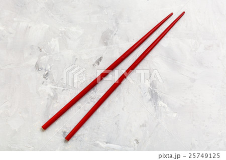red wooden chopsticks on concrete board 25749125