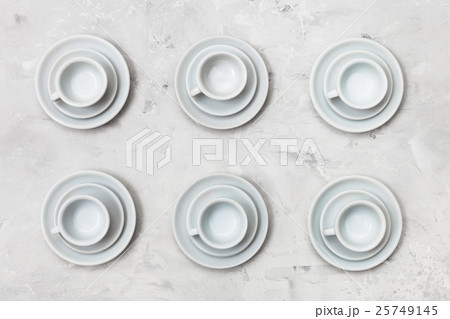 top view of six white cups and saucers on concrete top view of six white cups and saucers on concrete 25749145