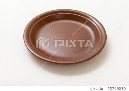 brown plate on white plastering board 25749230