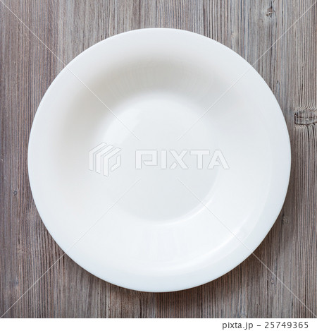 top view of white deep plate on gray brown table top view of white deep plate on gray brown table 25749365