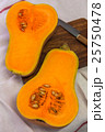 Squash cut in half on a wooden board 25750478