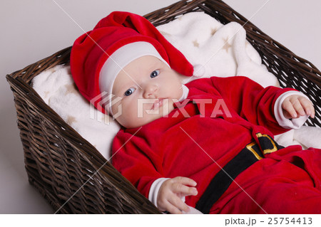 cute baby with santa costume lying in basket cute baby with santa costume lying in basket 25754413