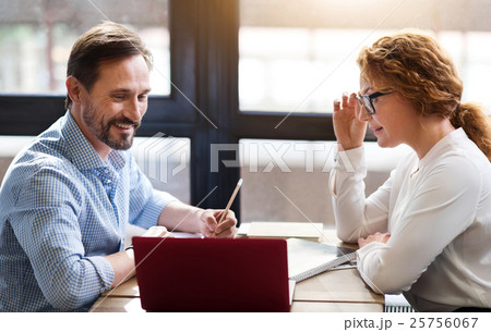 Middle-aged couple working on laptop and taking Middle-aged couple working on laptop and taking 25756067