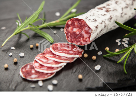 Salami on dark background Salami on dark background 25757722