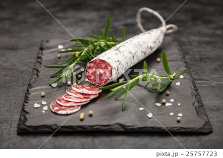 Salami on dark background Salami on dark background 25757723