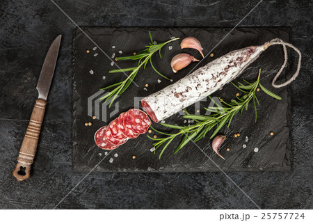 Salami on dark background 25757724