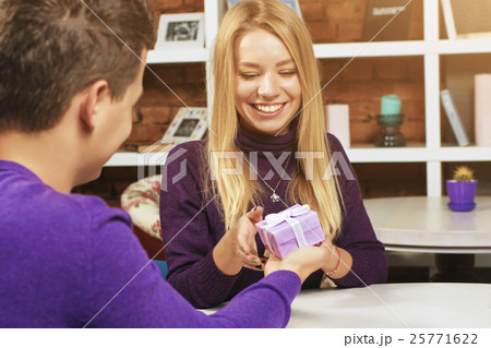 Young man making a gift to the girl 25771622
