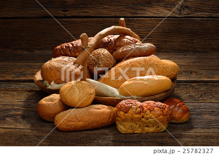 Variety of bread on old wooden background. 25782327