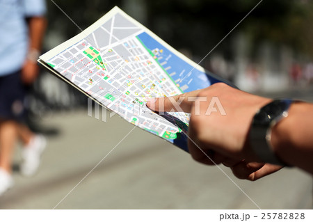 man is looking for directions on the map outside man is looking for directions on the map outside 25782828