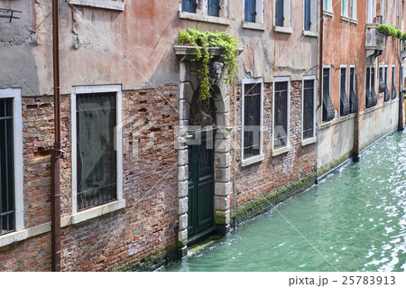 Venice cityscape. Narrow canal among old colorful  25783913