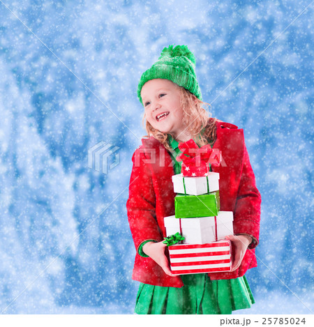Little girl holding Christmas presents Little girl holding Christmas presents 25785024