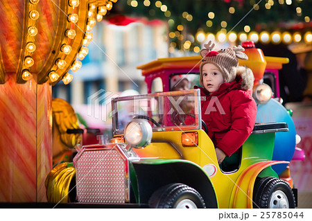 Child riding carousel on Christmas market 25785044