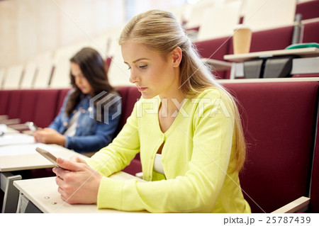 student girls with smartphones on lecture student girls with smartphones on lecture 25787439