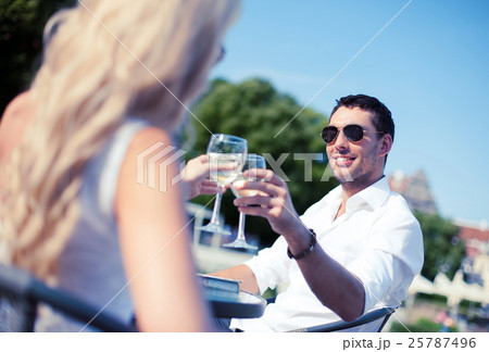 couple drinking wine in cafe 25787496