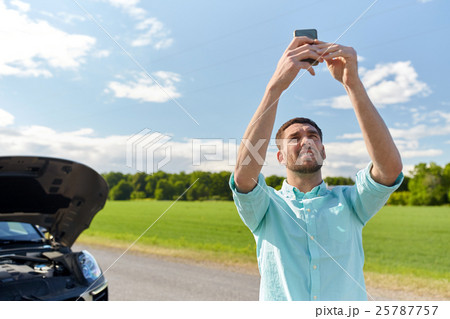 man with smartphone and broken car at countryside 25787757