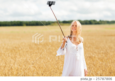happy young woman taking selfie by smartphone happy young woman taking selfie by smartphone 25787806