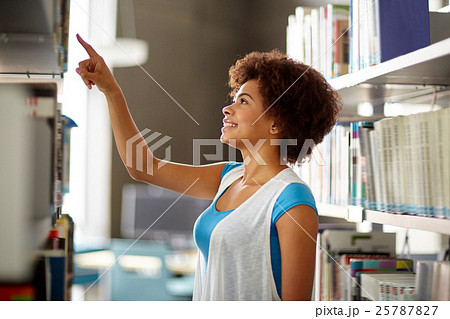 african student girl pointing to book at library african student girl pointing to book at library 25787827