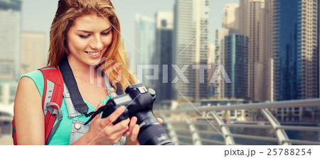 woman with backpack and camera over dubai city woman with backpack and camera over dubai city 25788254