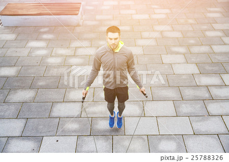 man exercising with jump-rope outdoors man exercising with jump-rope outdoors 25788326