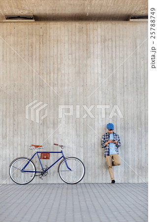 man with smartphone, earphones and bicycle man with smartphone, earphones and bicycle 25788749