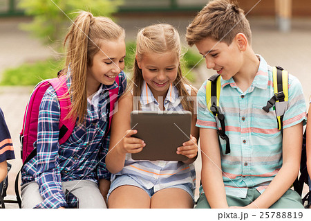 group of happy elementary school students talking 25788819