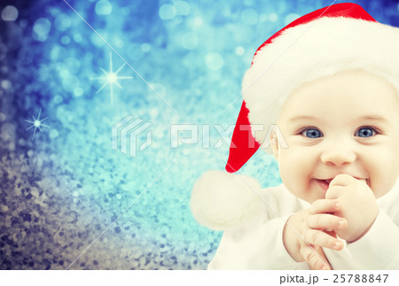 happy baby in santa hat over blue holidays lights 25788847