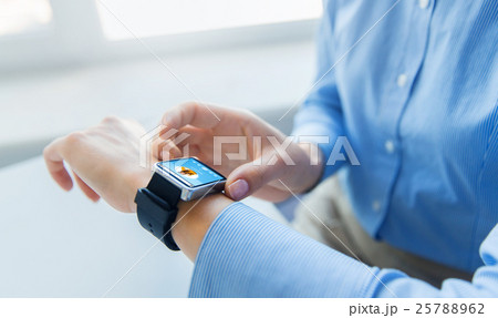 close up of hands with music player on smart watch close up of hands with music player on smart watch 25788962