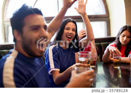 football fans with beer celebrating victory at bar 25789128