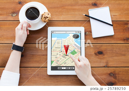 close up of woman with tablet pc on wooden table 25789250