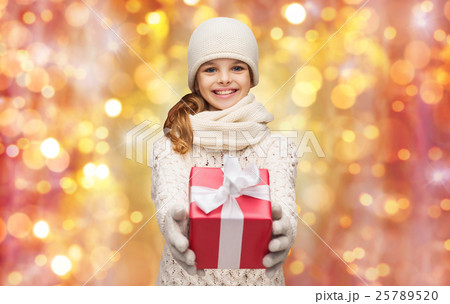 happy girl in hat, scarf and gloves with gift box happy girl in hat, scarf and gloves with gift box 25789520