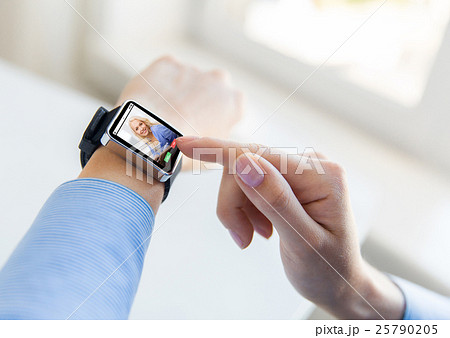 close up of hands with incoming call on smartwatch close up of hands with incoming call on smartwatch 25790205