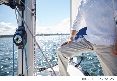 close up of senior man on yacht sailing in sea 25790325