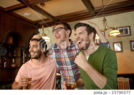 friends with beer watching sport at bar or pub friends with beer watching sport at bar or pub 25790377