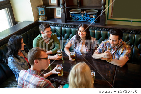 happy friends drinking beer at bar or pub 25790750