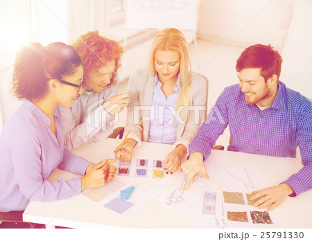 smiling creative team looking at sketch 25791330