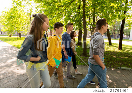 group of happy teenage students walking outdoors 25791464