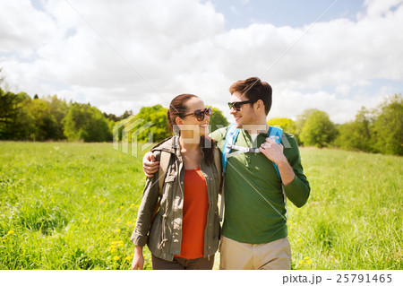happy couple with backpacks hiking outdoors 25791465