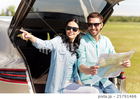 happy man and woman with road map at hatchback car 25791466
